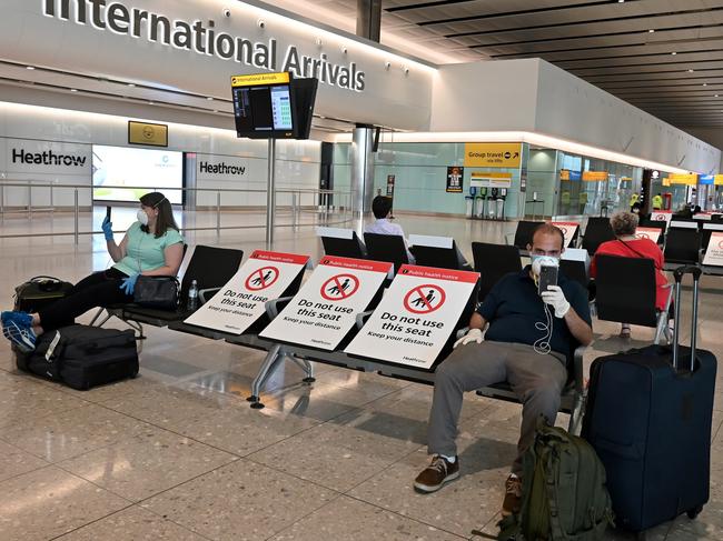 Passengers wearing PPE at London’s Heathrow Airport. Picture: AFP