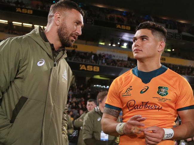 AUCKLAND, NEW ZEALAND - AUGUST 07: Noah Lolesio of the Wallabies chats with teammates Quade Cooper and Duncan Paia'Aua after the Rugby Championship and Bledisloe Cup match between the New Zealand All Blacks and the Australia Wallabies at Eden Park on August 07, 2021 in Auckland, New Zealand. (Photo by Anthony Au-Yeung/Getty Images)