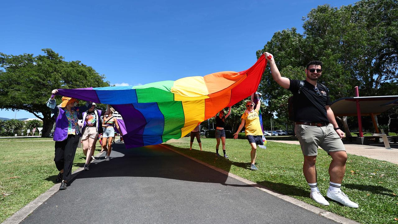 A small group of LGBTIQ people and supporters paraded along the Cairns Esplanade with a huge rainbow flag for the Pride Stride, part of the Cairns Pride Festival. Picture: Brendan Radke