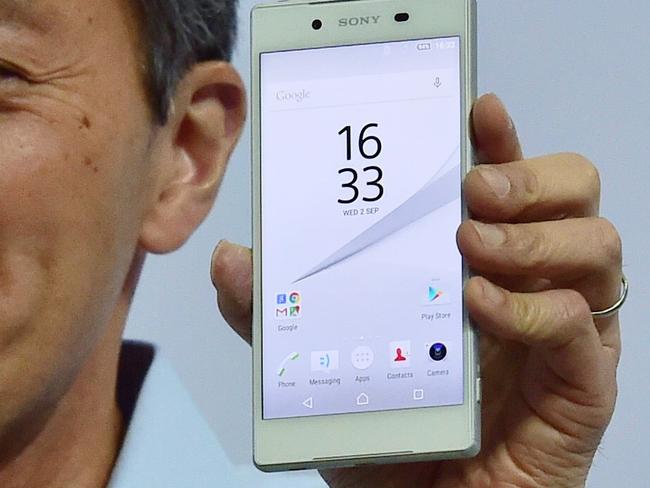 Japan's electronics giant Sony president Kazuo Hirai presents the company’s new smartphone Xperia Z5 ahead of the opening of the 55th IFA (Internationale Funkausstellung), on September 2, 2015 in Berlin. IFA, one of the world's biggest consumer electronics shows, opens for the media before the public is invited from September 4 to 9. AFP PHOTO / JOHN MACDOUGALL