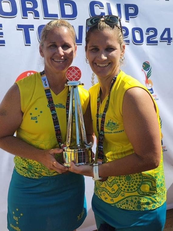 Sisters Kim Reibel and Toni Chirio with the cherished Masters World Cup trophy.