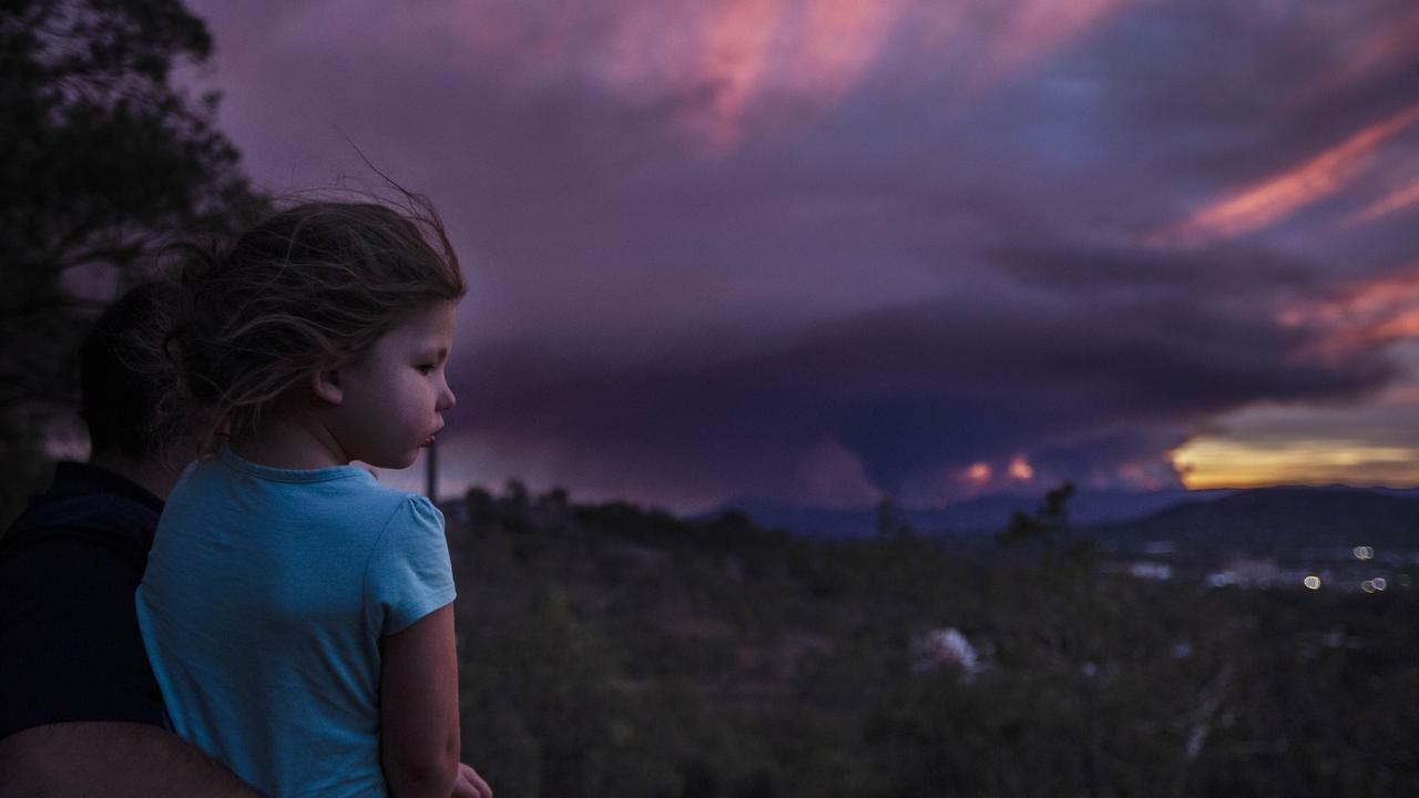 Julian Smith, 27 yrs old with his young 3 year old daughter Emily looking out at the fire to south of them. Picture Gary Ramage