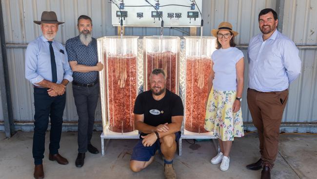 Rowan Ramsey, Steve Meller, Senator Anne Ruston and state MP for Flinders, Sam Telfer, and Adam Main kneeling, with tanks of asparagopsis. Supplied