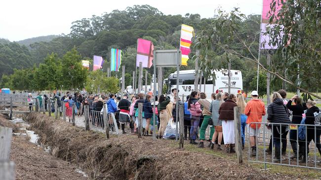 Lines of festival-goers heading back to Byron after organisers pulled the plug on day one. 22 July 2022 Byron Bay. Picture: Richard Gosling