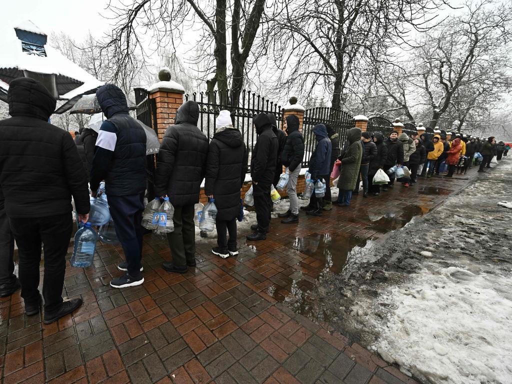 Local residents queue for access to a water pump in a park to fill plastic bottles in Kyiv. Picture: AFP