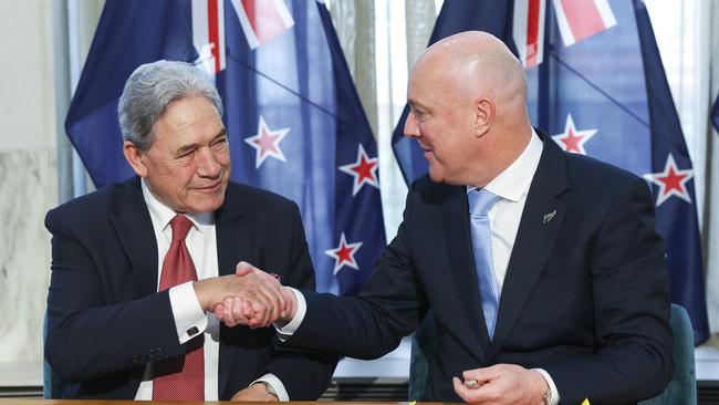 New Zealand First leader Winston Peters and incoming Prime Minister Christopher Luxon sign the coalition agreement. Picture: Getty Images.