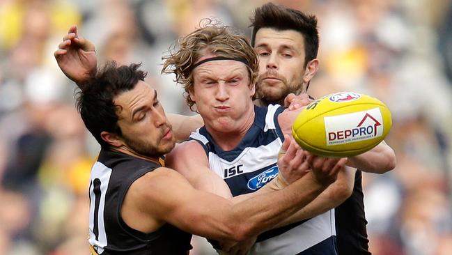 Josh Caddy is tackled by potential 2017 teammates Shane Edwards and Trent Cotchin.