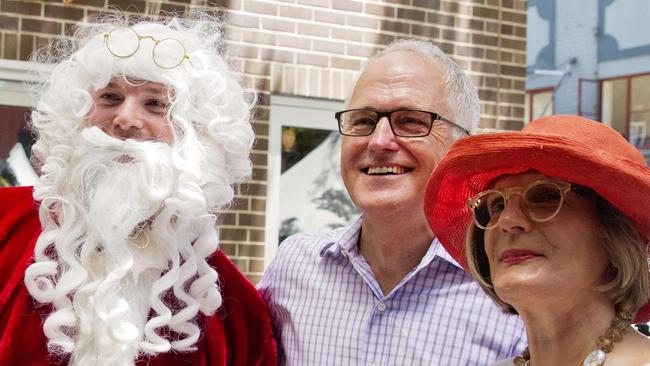 Australian PM Malcolm Turnbull at the Wayside Chapel in Sydney today to hand out food. Malcolm with wife Lucy and Santa.  Pic Jenny Evans