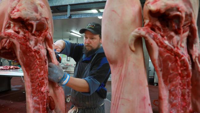 Butcher Kieran Kennedy carves it up. He is one of 20 workers in the meat department. Picture: Angelo Velardo