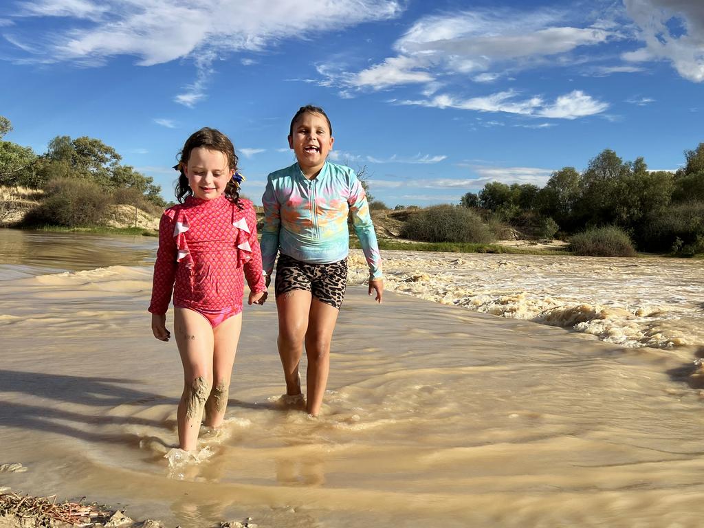 Elle Birchley and Harmony Dodd play in the water at the Old Diamantina River Crossing, Birdsville. Picture: Sam Watkins