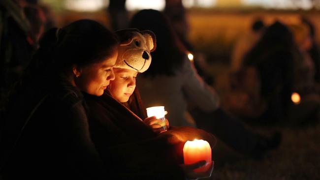 Claudia and Ella Yakubchak at a candlelight vigil held at the shopping centre the night of the accident. Picture: AAP/Josh Woning