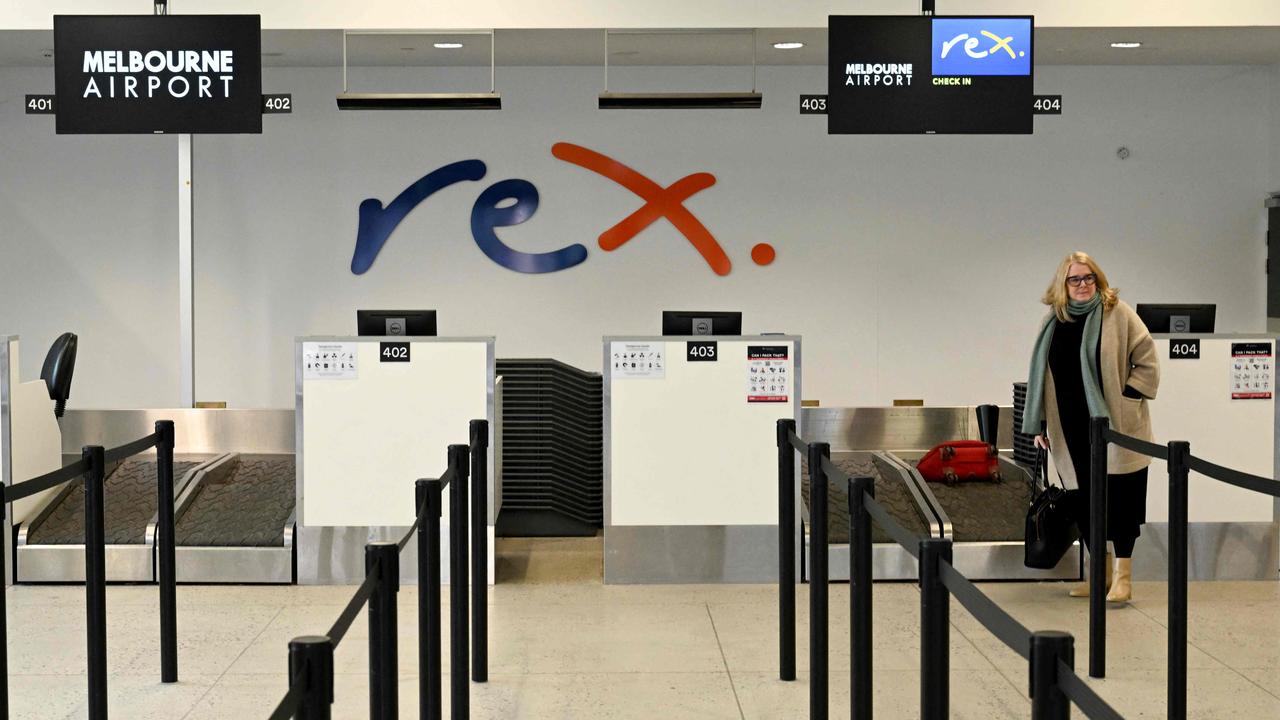 A passenger checks in for a Rex Airlines flight at Melbourne's Tullamarine Airport on Wednesday. Picture: William WEST/AFP