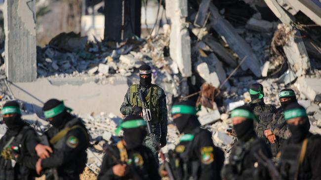 Palestinian militant group Hamas fighters secure an area before handing over the two Israeli hostages to a Red Cross team in Khan Younis in Gaza on Saturday. Picture: AFP