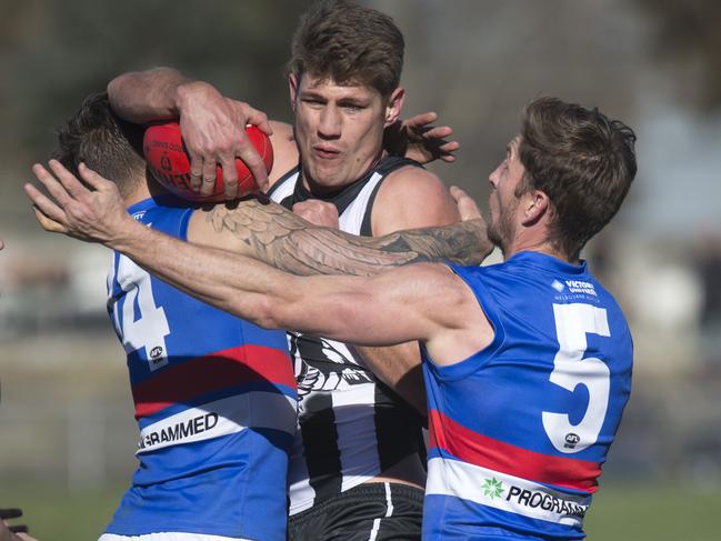 VFL Collingwood v Footscray at Victoria Park, Abbotsford. Footscrays, No 14 Clay Smith and No 5 (not in record ) tackle Collingwood's No. 65 Lachlan Howe.  Picture: Sarah Matray