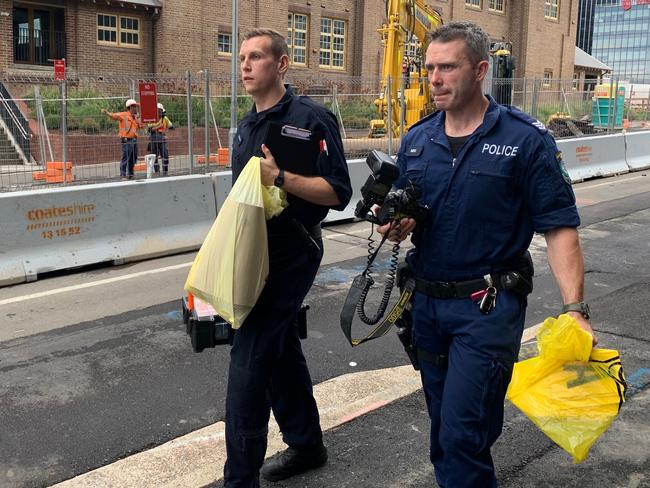 Police with evidence bags outside the school. Picture: Nick Hansen