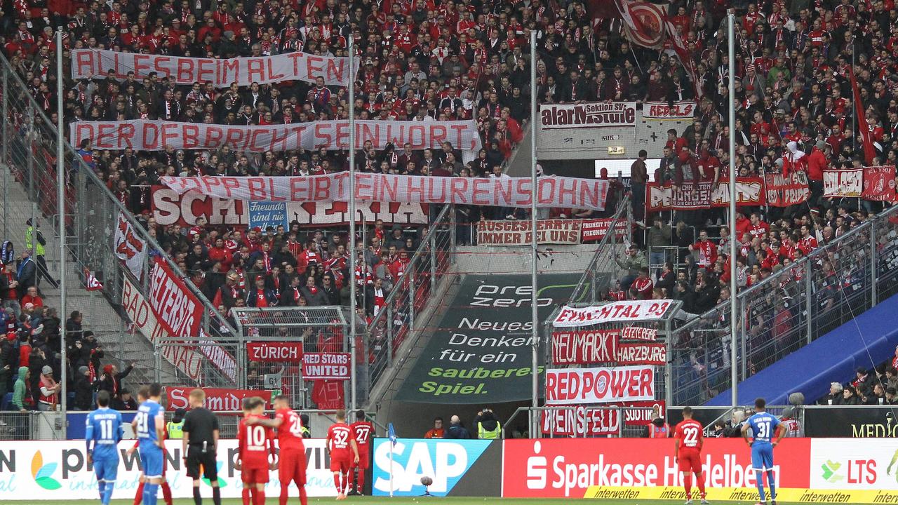 Bayern Munich supporters unveiled banners targeting Hoffenheim owner Dietmar Hopp, causing ridiculous scenes.