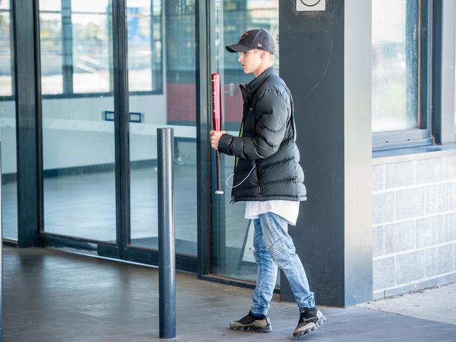 A youth involved in the standoff carries a baseball bat. Picture: Jake Nowakowski