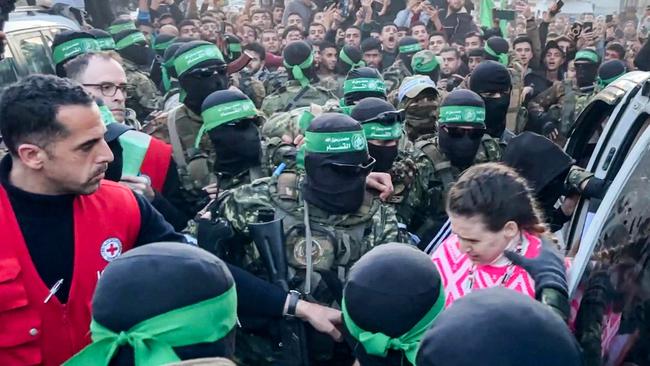 The first Israeli hostages are handed over to the International Committee of the Red Cross during the hostage-prisoner exchange operation in Saraya Square in western Gaza City. Picture: AFP