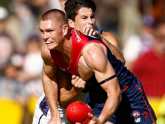 ALICE SPRINGS, AUSTRALIA - JUNE 02: Adam Tomlinson of the Demons is tackled by Bailey Banfield of the Dockers during the 2024 AFL Round 12 match between the Melbourne Demons and the Fremantle Dockers at TIO Traeger Park on June 02, 2024 in Alice Springs, Australia. (Photo by Michael Willson/AFL Photos via Getty Images)