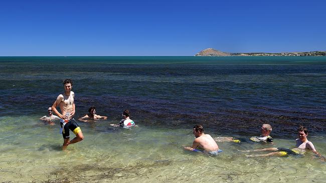 ADELAIDE, AUSTRALIA - JANUARY 18:  (EDITORS NOTE: A polarizing filter was used for this image.) Riders cool off in the ocean after stage three of the 2018 Tour Down Under on January 18, 2018 in Adelaide, Australia.  (Photo by Daniel Kalisz/Getty Images)