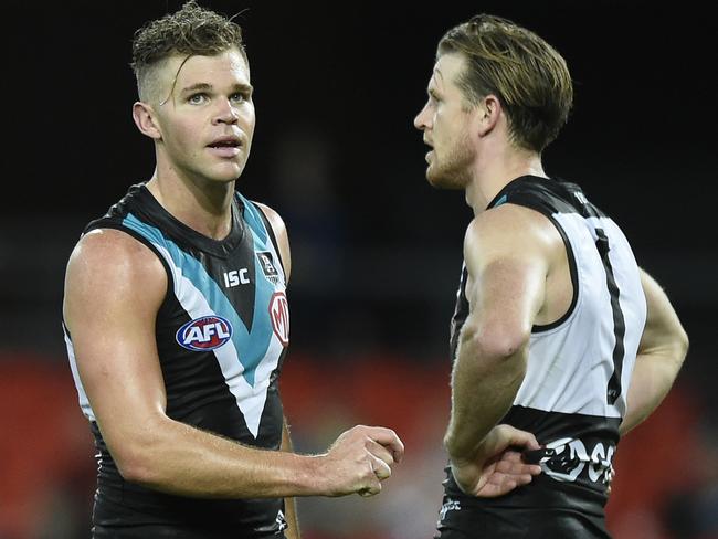 GOLD COAST, AUSTRALIA - AUGUST 14: Dan Houston and Tom Jonas of the Power speak during the round 12 AFL match between the Geelong Cats and the Port Adelaide Power at Metricon Stadium on August 14, 2020 in Gold Coast, Australia. (Photo by Matt Roberts/Getty Images)