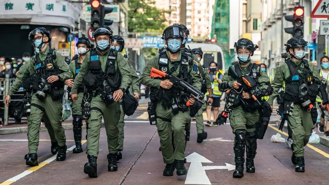 Riot police charge on a Hong Kong street during an anti-government protest on Sunday. Picture: Getty Images