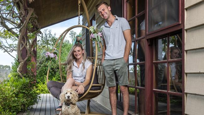 Jamie Kah with partner Clayton Douglas and their dog Bubbles. Picture: Jake Nowakowski