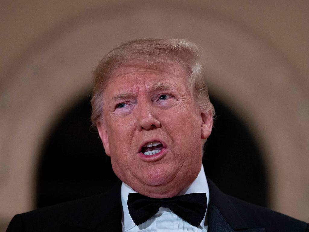 Then-US President Donald Trump speaks to the press outside the grand ballroom as he arrives for a New Year's celebration at Mar-a-Lago in Palm Beach, Florida on December 31, 2019. Picture: Jim Watson / AFP.