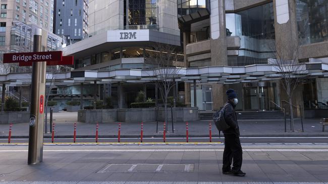 A man wearing a mask at the Bridge Street tram stop in Sydney last week. Picture: Getty Images