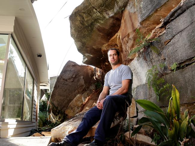 Joel Gloede inspects damage to his home after a rock wall collapsed onto part of it Picture: Troy Snook