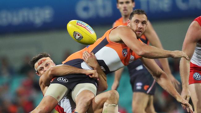 Sydney's Callum Sinclair tackles Giants Shane Mumford during the AFL Derby match between the Sydney Swans and GWS Giants at the SCG. Picture. Phil Hillyard