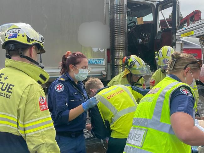 The woman had to be extricated from under the large truck by paramedics and Fire and Rescue crews. Photo: CareFlight