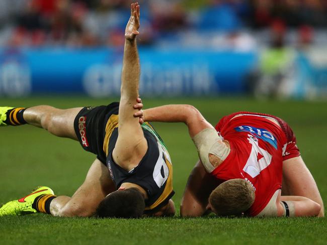 Richmond’s Trent Cotchin and Sydney’s Dan Hannebery get accustomed with the ANZ Stadium turf. Or should that be “cow paddock”?