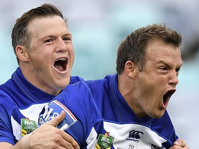 Josh Morris of the Bulldogs (right) celebrates with brother Brett (left) after scoring a try during the Round 3 NRL match between the Canterbury-Bankstown Bulldogs and the Penrith Panthers at ANZ Stadium in Sydney, Friday, March 23, 2018. (AAP Image/Dan Himbrechts) NO ARCHIVING, EDITORIAL USE ONLY