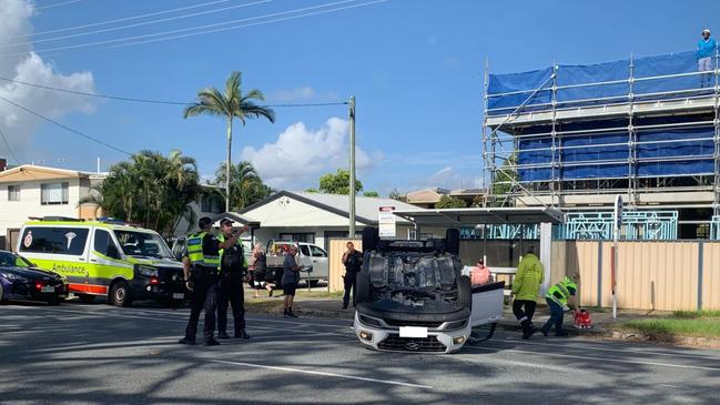 BLURRED A white hatchback has flipped upside down after careening through Bayview St, Hollywell. Picture: Kathleen Skene