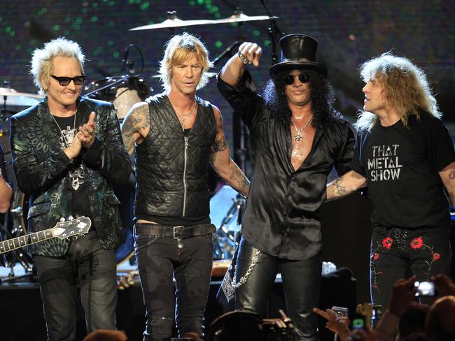 Guns’n’Roses (l-r): Matt Sorum, Duff McKagan, Slash and Steven Adler appear on stage at their induction into the Rock and Roll Hall of Fame in Cleveland. Frontman Axl Rose skipped the event, saying it didn't ‘appear to be somewhere I'm actually wanted or respected’. Picture: AP Photo/Tony Dejak