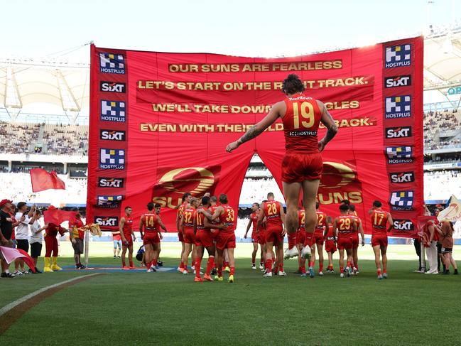 PERTH, AUSTRALIA - MARCH 16: The Suns run out onto the field during the round one AFL match between West Coast Eagles and Gold Coast Suns at Perth Stadium, on March 16, 2025, in Perth, Australia. (Photo by Paul Kane/Getty Images)