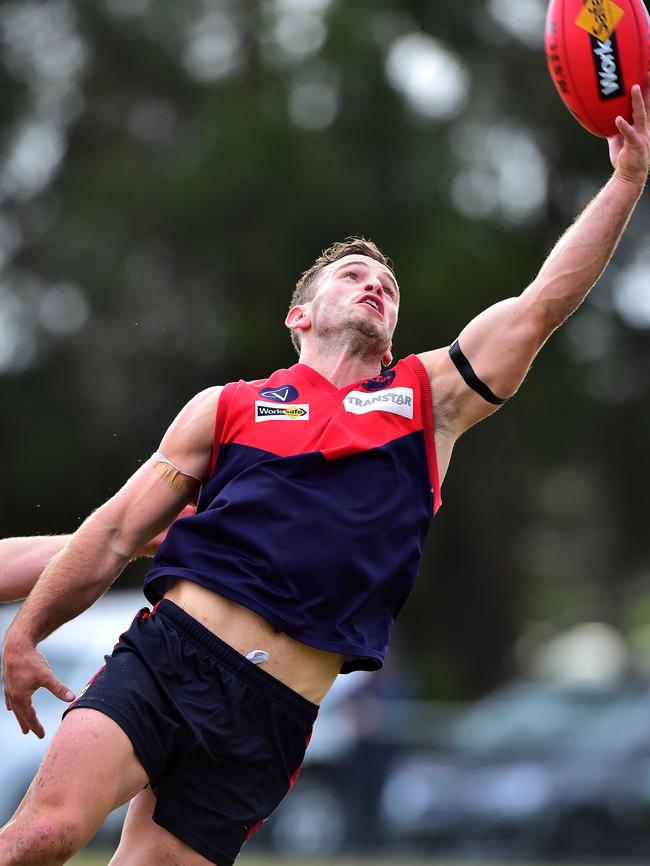 Mt Eliza midfielder Rohan Heasley plucks a one-hander. Picture: Derrick den Hollander