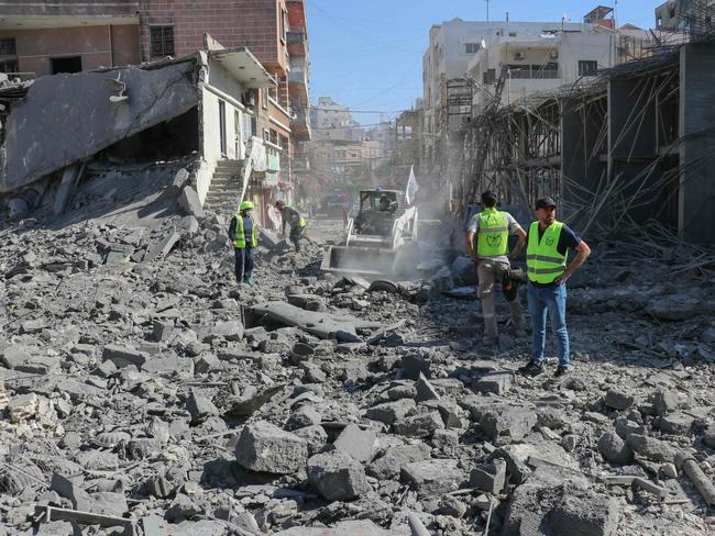 Emergency services clear the rubble from the site of an Israeli strike that targeted the southern Lebanese city of Tyre on October 23, 2024. Israel expanded operations in Lebanon nearly a year after Hezbollah began exchanging fire in support of its ally, Hamas, following the Palestinian group's attack on Israel in October 2023. (Photo by KAWNAT HAJU / AFP)