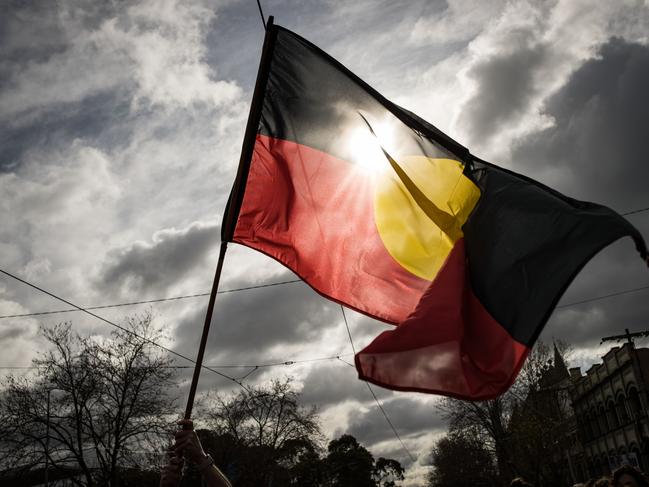 MELBOURNE, AUSTRALIA - JULY 07: The Aboriginal flag is seen flying during the NAIDOC March on July 07, 2023 in Melbourne, Australia. NAIDOC Week is an Australian observance lasting from the first Sunday in July until the following Sunday. The acronym NAIDOC stands for National Aborigines and Islanders Day Observance Committee. The week is intended as a time when all Australians can reflect on the rich history of the country's indigenous peoples, and learn about the cultures and histories of first nations groups. (Photo by Darrian Traynor/Getty Images)