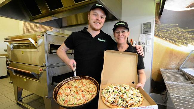 NEW ADDITION: Jessee and Tracey Heilbronn from Pizza Plus in Raceview and North Ipswich. INSET: Jessee hard at work. Picture: David Nielsen