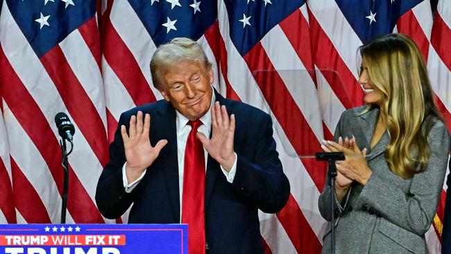 Donald Trump gestures after speaking during an election night event at the West Palm Beach Convention Centre, alongside wife Melania. Picture: AFP