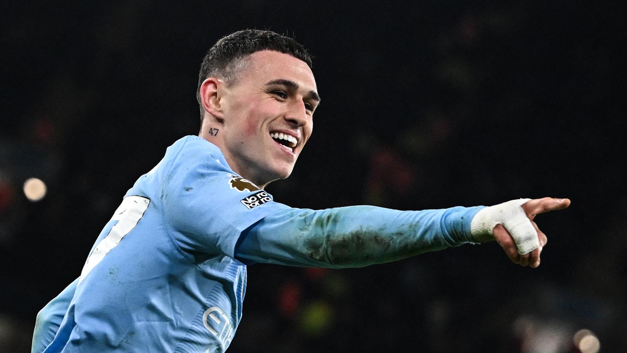 Phil Foden celebrates after scoring. (Photo by Paul ELLIS / AFP)/