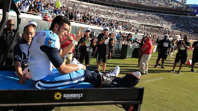 Marcus Mariota #8 of the Tennessee Titans waves as he is carted off the field.
