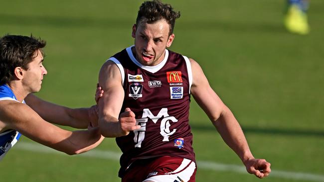 Lachlan Hickey gets a kick for Melton. Picture: Andy Brownbill