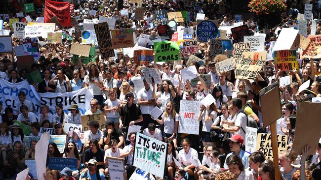 Students from different schools raise placards during a protest rally for climate change awareness at Martin Place in Sydney last November.