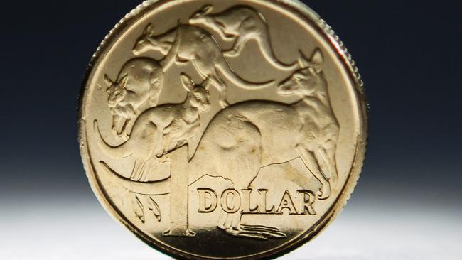 An Australian one-dollar coin is arranged for a photograph in Sydney, Australia, on Wednesday, April 17, 2013. Direct trading between the Australian dollar and yuan started on April 10. Photographer: Ian Waldie/Bloomberg