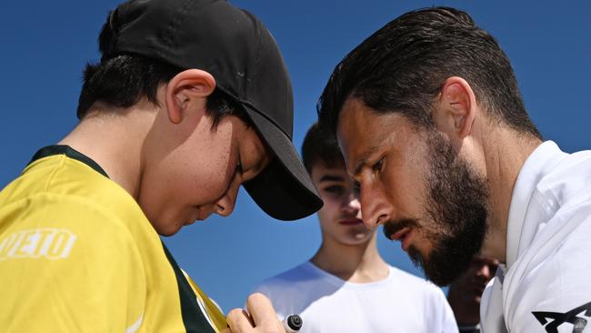 BRISBANE, AUSTRALIA - NewsWire Photos - SEPTEMBER 20, 2022.Socceroo Mathew Leckie signs autographs to young fans during a visit to the Mitchelton FC in Brisbane. The Socceroos will play against New Zealand on Wednesday night. Picture: NCA NewsWire / Dan Peled