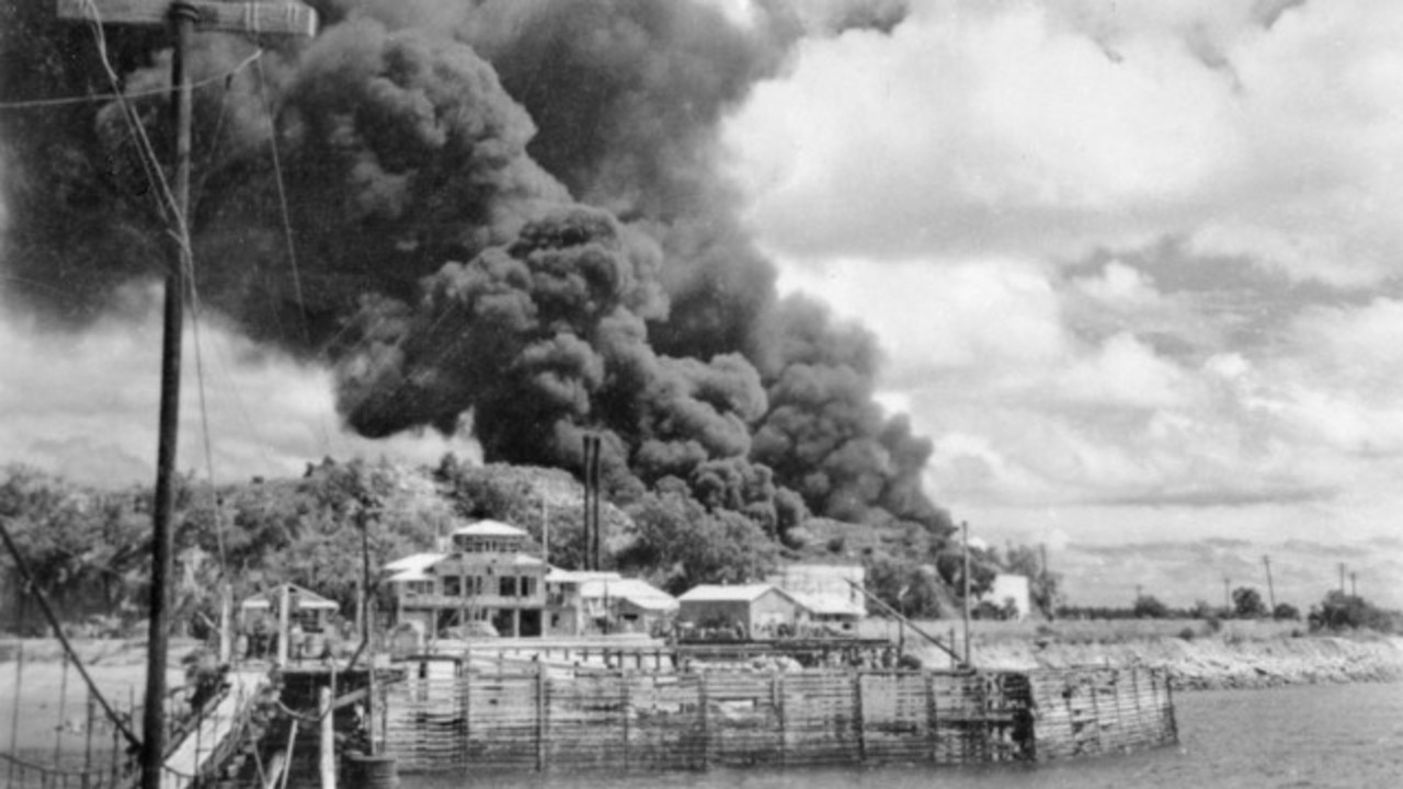 Stokes Hill oil tanks burning during Japan's first air raid. Photo: Australian War Memorial.