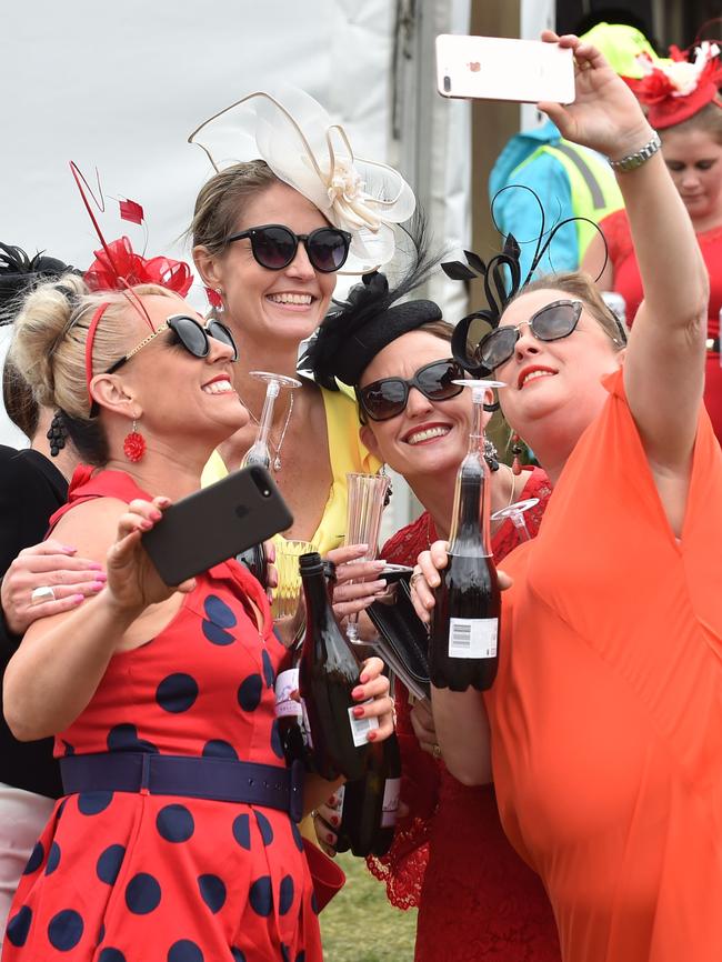 Women pose for a selfie at Flemington. Picture: AFP